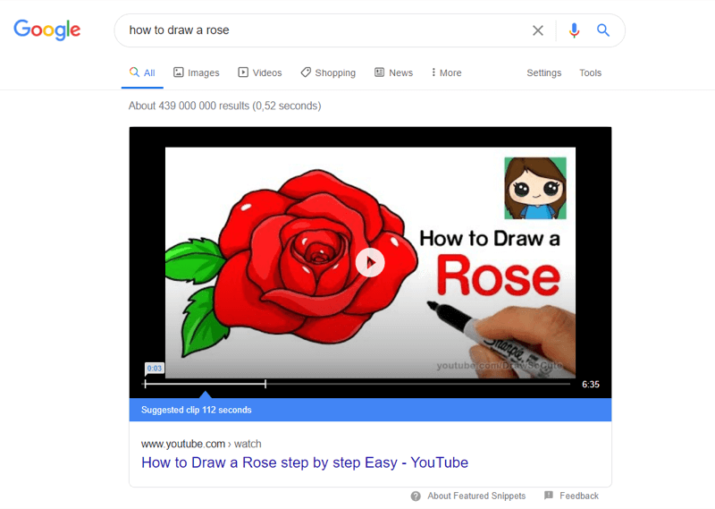 przykład najlepszych filmów z YouTube w wynikach wyszukiwania Google dla „jak narysować różę”