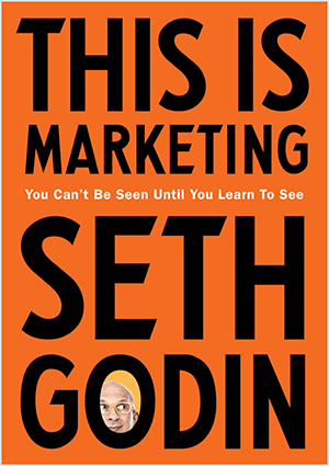 To jest zrzut ekranu okładki This Is Marketing autorstwa Setha Godina. Okładka to pionowy prostokąt z pomarańczowym tłem i czarnym tekstem. Zdjęcie głowy Setha pojawia się w O jego nazwiska.